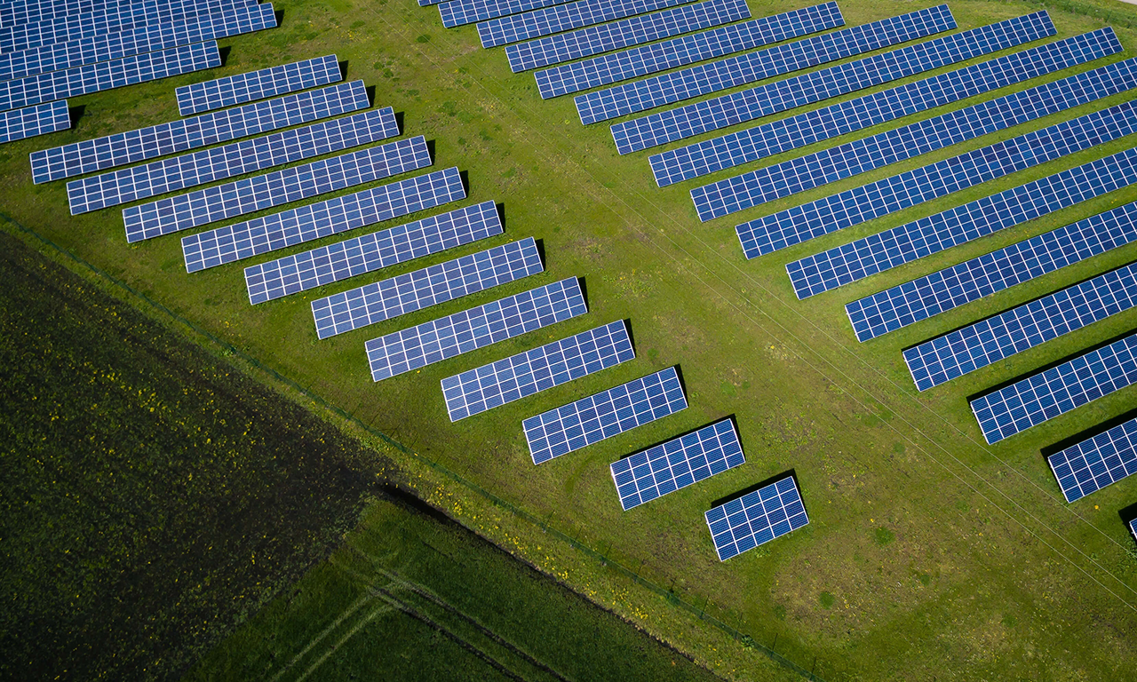 An aerial view of a field with solar panels