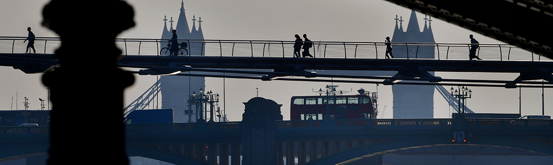 People walking over a London bridge